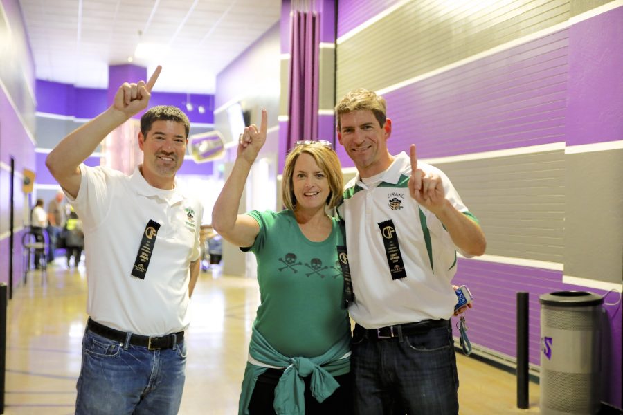 Drake administrators Chad Stuart (left), Liz Seabury (middle), and Eric Saibel (right) root for their basketball players. | Courtesy of Rod Miles