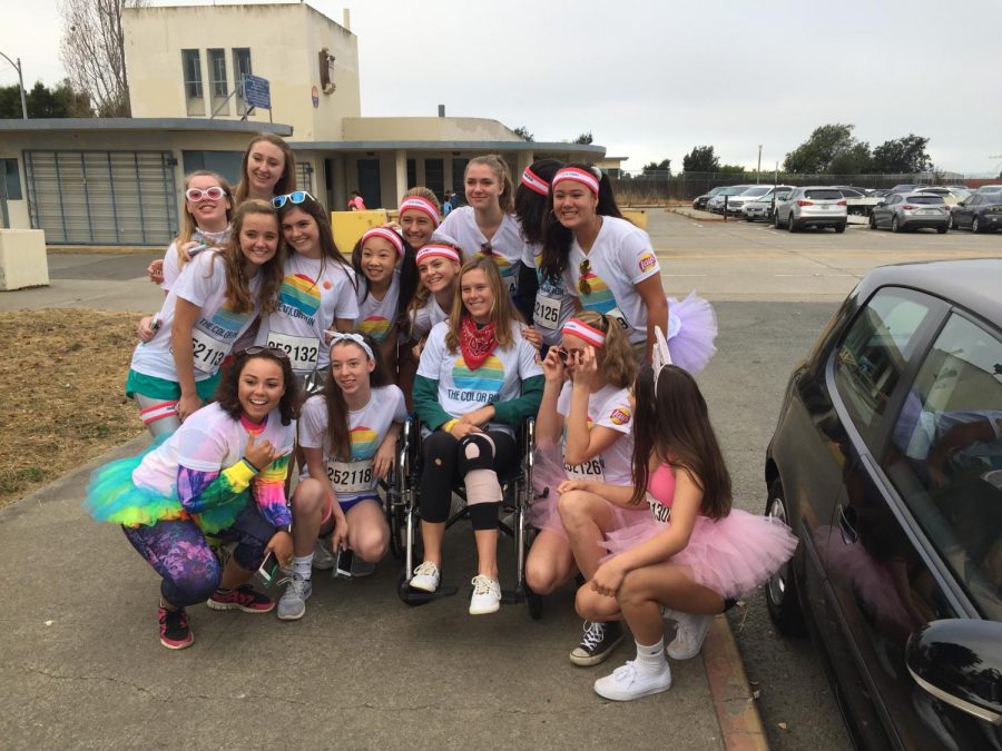 The+varsity+volleyball+team+pushes+Kirsty+%28center%29+in+a+wheelchair+at+the+Color+Run+5k+in+Alameda+on+Saturday%2C+Oct.+28.