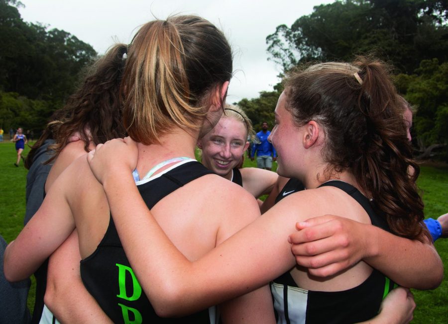 Girls Cross Country huddle before a race