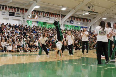 The girls basketball team preforms during the winter rally.