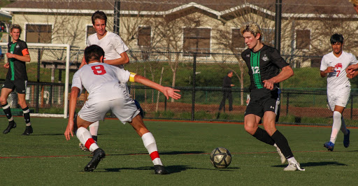 Sophomore George Dick maintains ball control while surrounded by San Rafael players. 