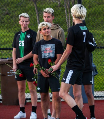 Senior players thank their parents and present roses after the game. (From the left: Griffin Waite, Erik Hargedahl, Keoni Schubert, Logan Smith)
