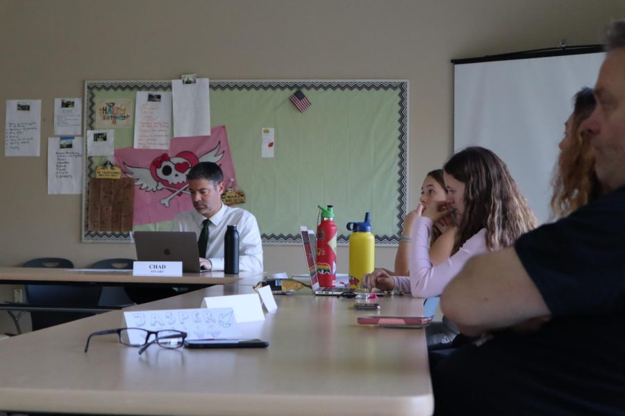Assistant Principal Chad Stuart takes notes on the meeting as Juniors Anya Bodine-McCoy, and Caitlin Fitzgerald, parent Erika Bradbury and teacher Jasper Thelin listen. 