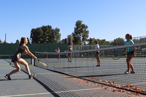 Girls water polo team practicing on the tennis courts for their last practice of the season.