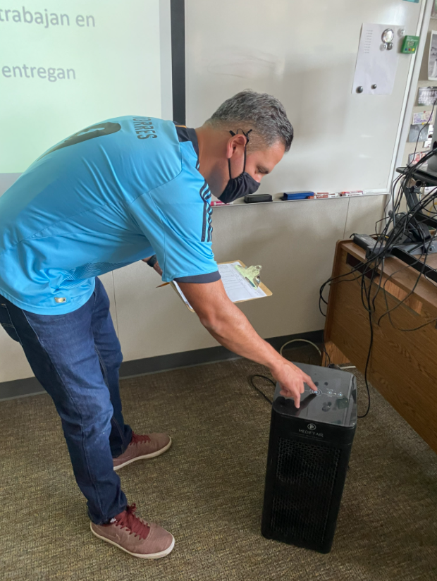 Senor Jose Anchordoqui turning on his classroom’s Medify air purifier, identical to what should be in every classroom.