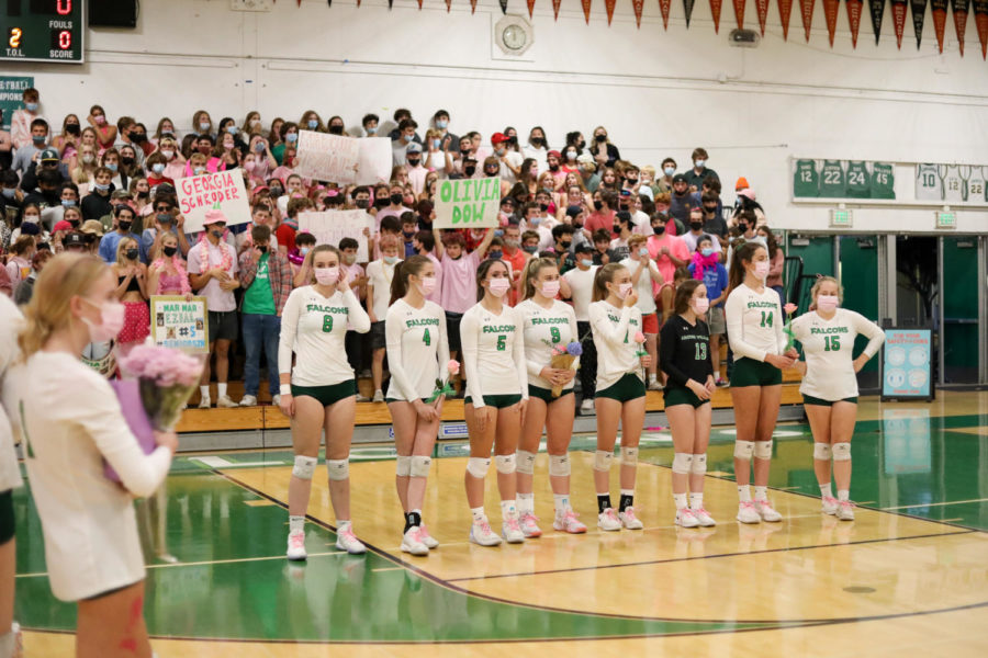 AWHS varsity girls volleyball seniors line up in front of the ‘Falcon’s Nest’ for senior night gifts and speeches. 