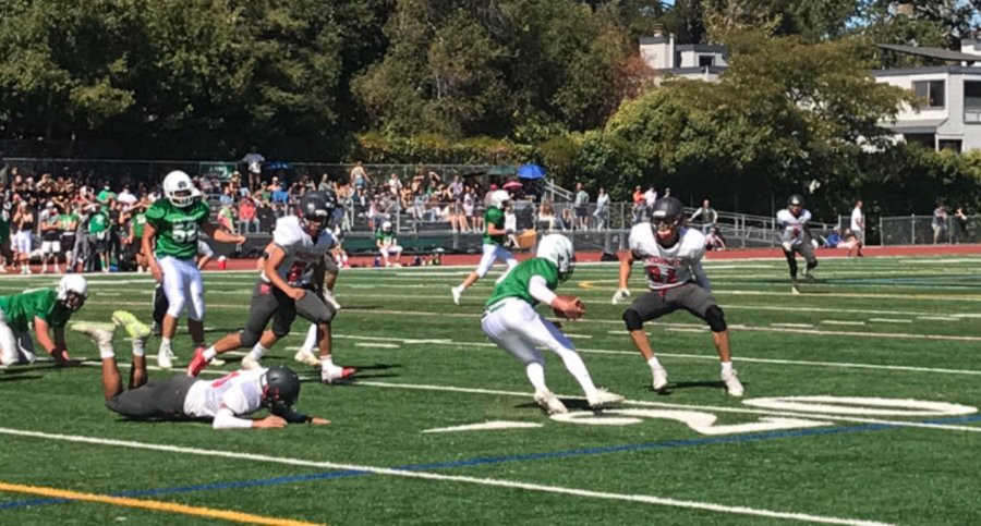 Junior varsity running back takes the ball upfield during Saturday’s game in San Anselmo.