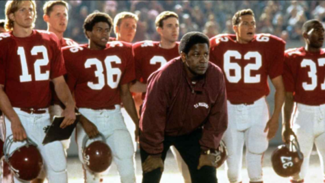 Coach Boone and team watch nervously as they play their rivals under the stadium’s lights. 