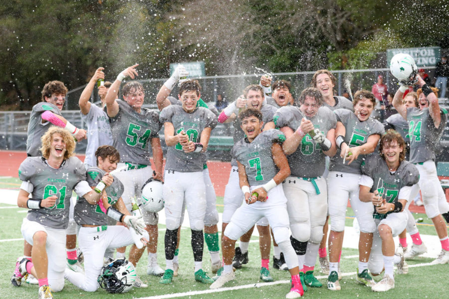 The AWHS football popping celebratory bottles after defeating San Rafael 29-22.
