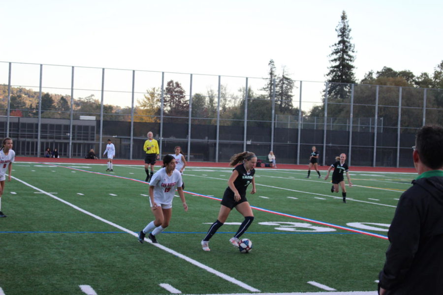 Senior midfielder Maya Wells dribbles around a San Rafael High player.