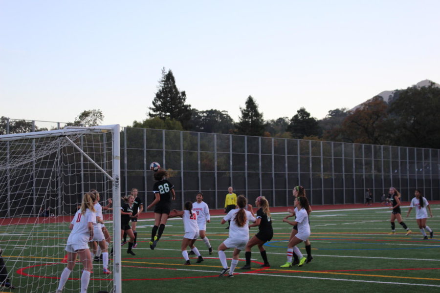 Freshman striker Phoebe Morf leaps to head the corner kick into the goal.
