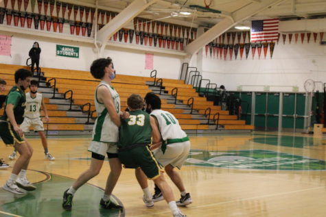 Sophomore guard Alex Martikan sets a screen on a San Marin defender, and junior guard Aiden Farnsworth attempts to dribble past the screened defender.