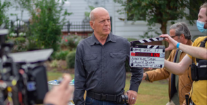 Bruce Willis portraying Ben Watts on the set of American Seige, before talking with local Businessman Charles Rutledge