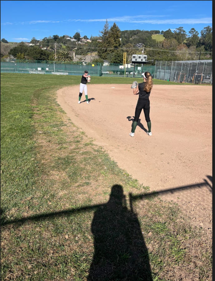 Senior Abby Murphy and sophomore Amelia Richer playing catch to warm up before practice.
