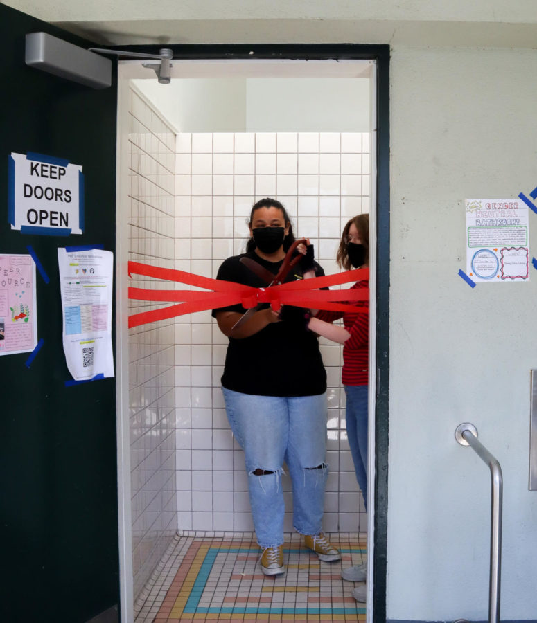ASB+students+Aubri+Ana+Koren+%28left%29+and+Ava+Gaughan+%28right%29+cut+the+ribbon%2C+opening+AWHSs+new+gender+neutral+bathroom.+