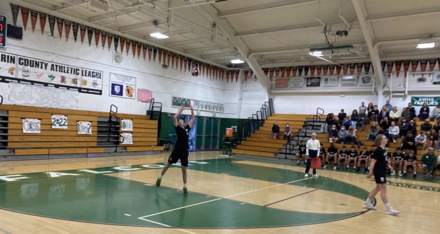 Senior setter and team captain Owen Johnson serves the ball from the back of the court, successfully setting the stage for the Falcons to score a point.
