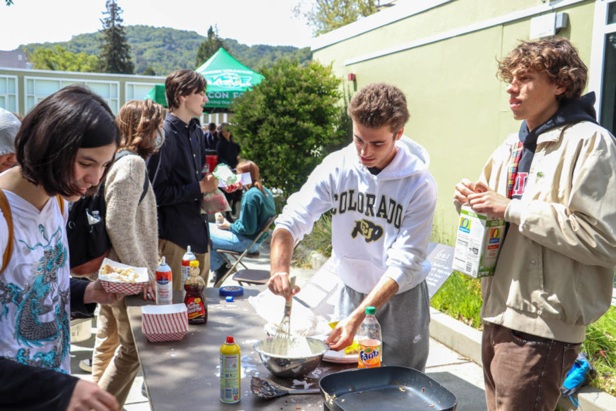 Senior James Worthington makes pancakes for other students, showcasing an electric burner.