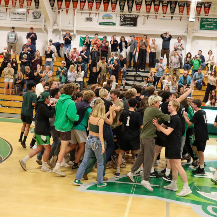 Falcons storm the court after the win on Friday night.