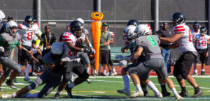 Falcons defense pounces on a Salesian Prep receiver in the final quarter on Saturday.