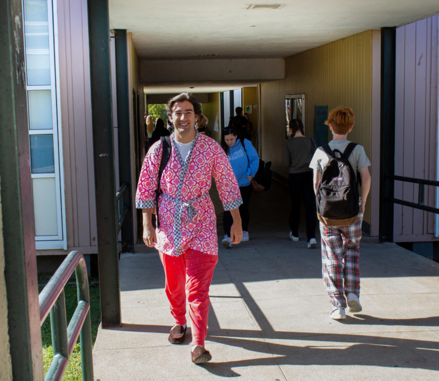 Senior Demetri Spielman walks the hallways in a robe, pajama pants, and slippers for PJ day.