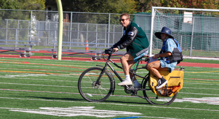 Co- Senior class president Micah Sher and ASB Vice President Lucy Hinkleman enter the rally on bike.