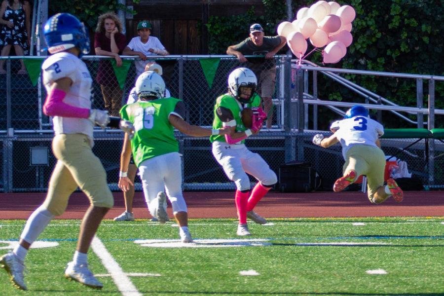 Junior Tony Rojas secures an interception for the Falcons during the Homecoming game on Oct. 8.