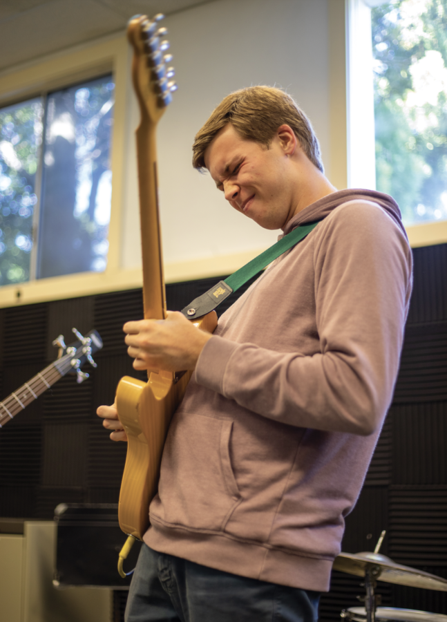 Bennett James practices the electric guitar during a tutorial.