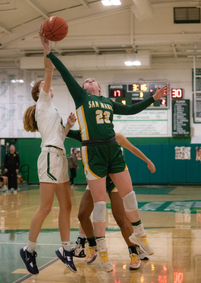 Junior forward Allegra Gabrielli-di Carpegna goes up for  a layup while being fouled by Mustang defender.