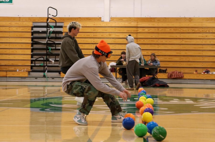 Senior Frankie Fradelizio lunges toward a dodgeball during the Snow Day dodgeball game.