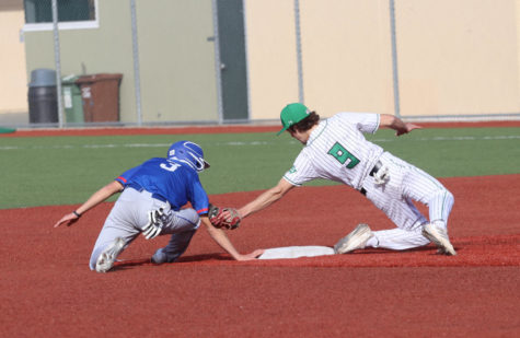 Junior shortstop Sam Black attempts to tag Hawks player Colin Lam as he come off the base.