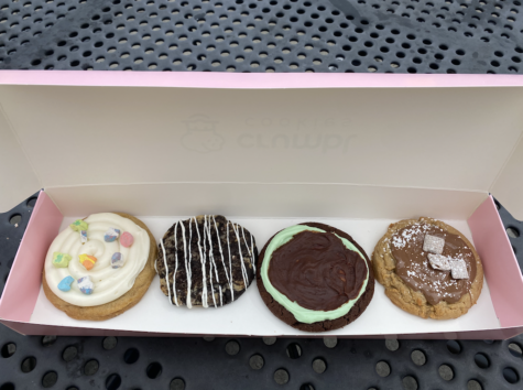 Crumbl’s signature pink box full of the best four offerings this week: Lucky Charms, Cookies & Cream, Mint Brownie, and Muddy Buddies (left to right).