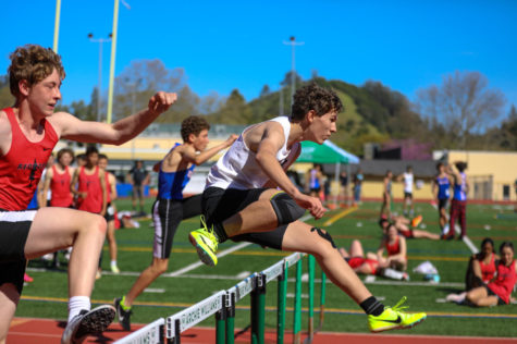 Sophomore Finn Ketcham noses out in front of boys 100 meter JV hurdlers from Redwood and Tam.