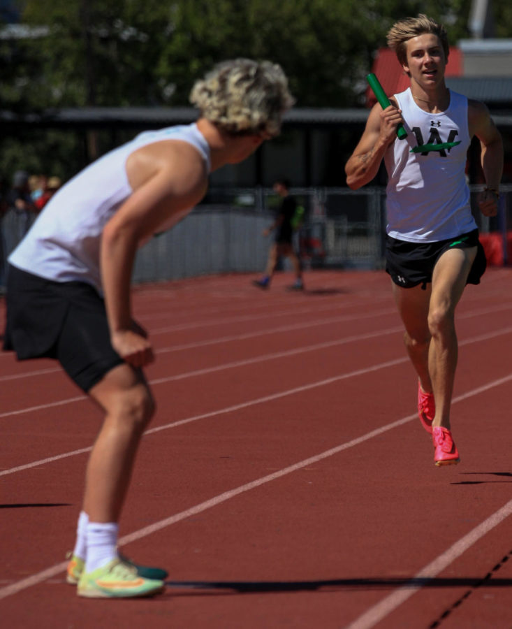 Junior John Minutoli sprints the final couple of meters of his leg of the 4 by 400 meter race at Redwood Empire Saturday May 13. He prepares to hand the baton off to second leg runner, junior Lochlan McLean.