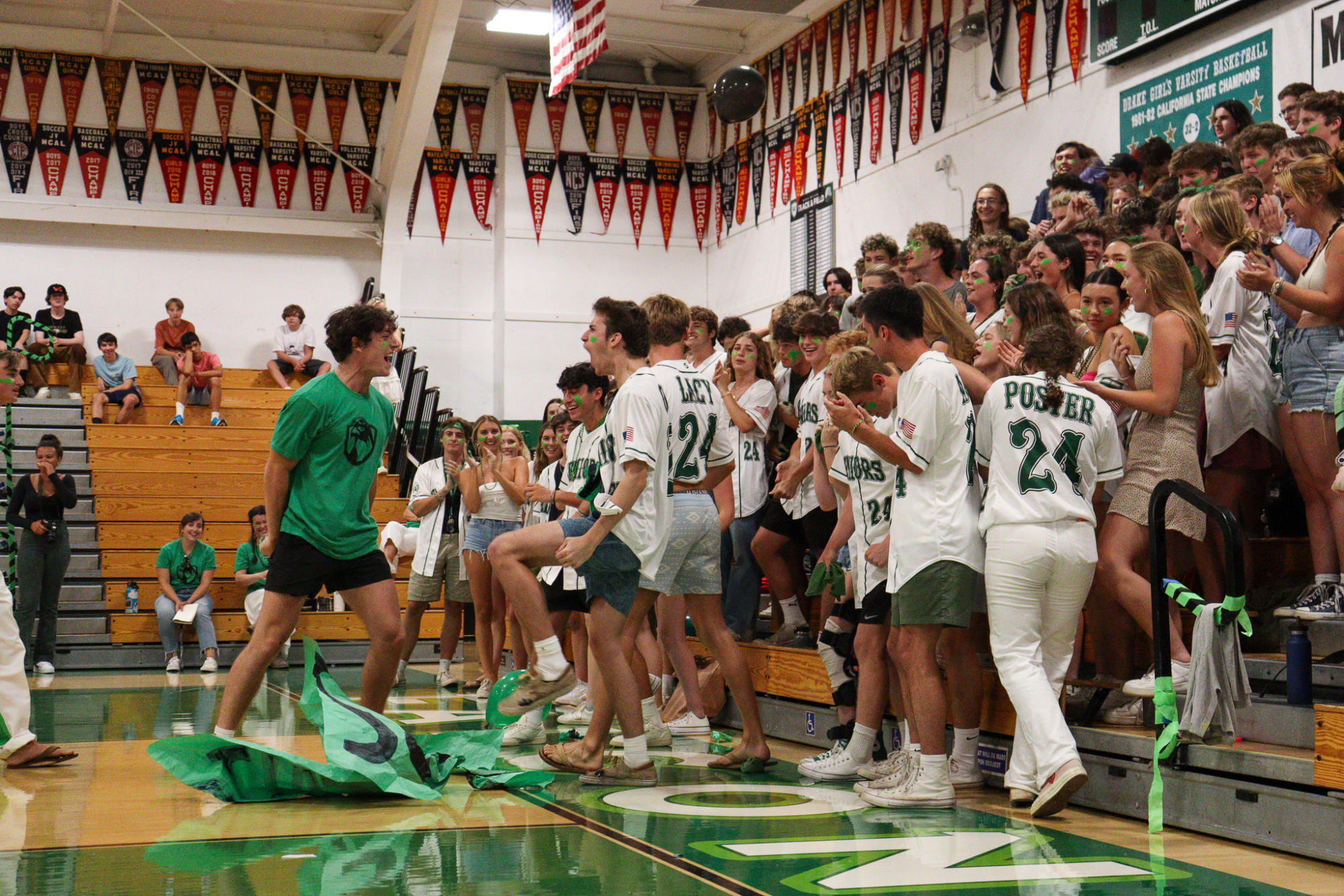 Senior Owen Bugas and senior Sutter OBrien cheer each other on in front of the Senior section.