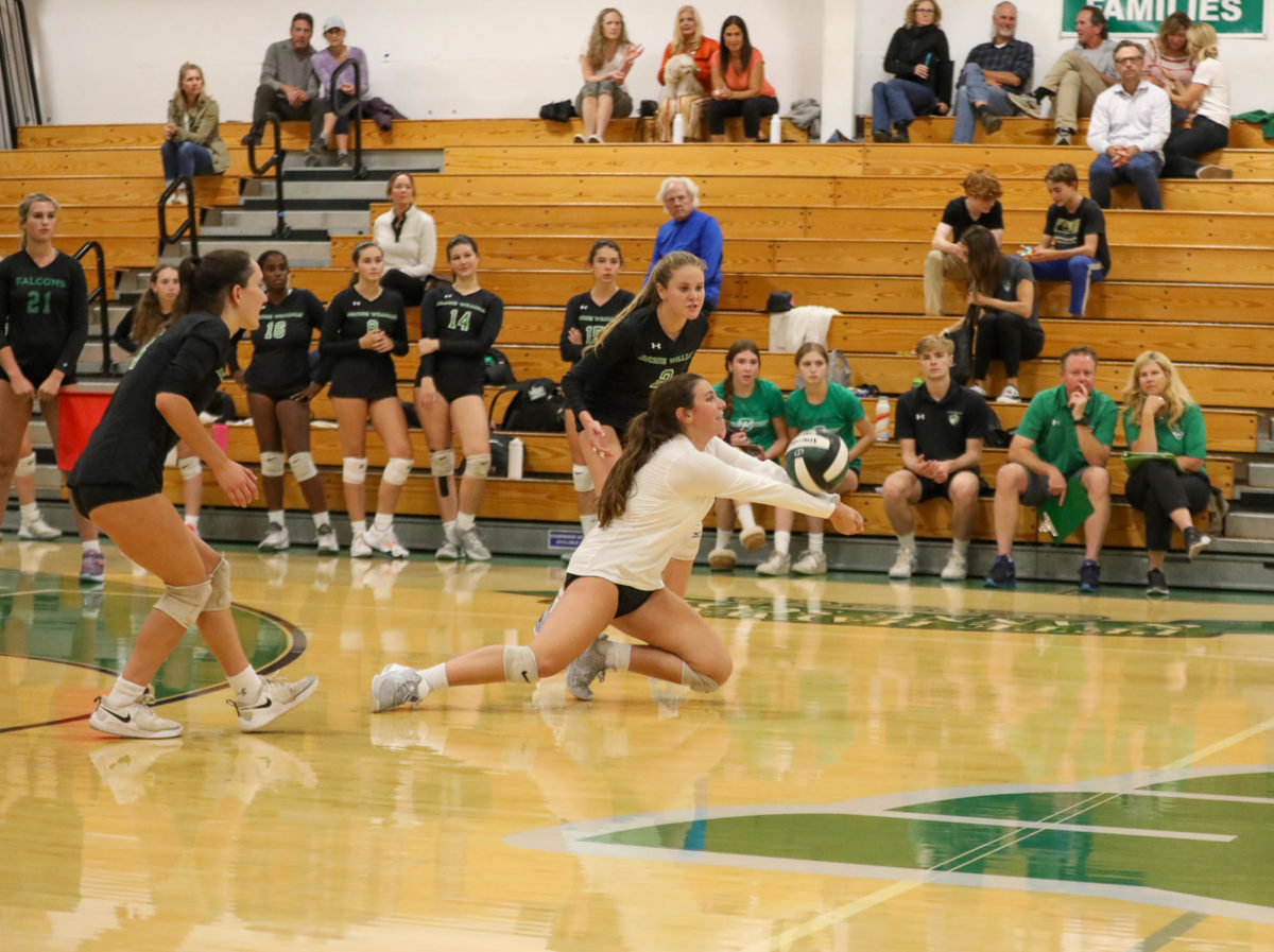 Sophomore Alyse Rosen goes for a dig to save the play.