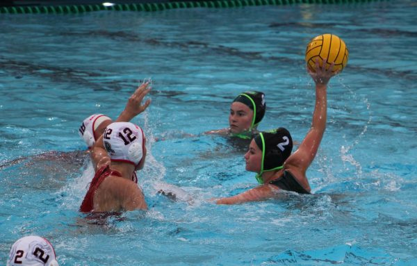 Senior Cate Logan looks to shoot the ball past the Redwood defenders.