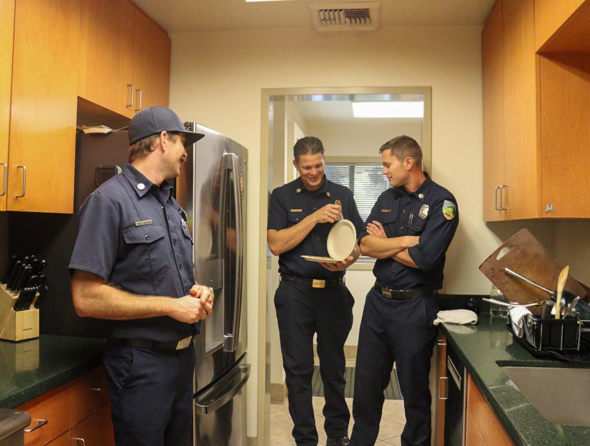Battalion chief Gavin Illingworth shares a plate of cookies with engineers and paramedics Tommy Pastalka and Nick Hurn. 