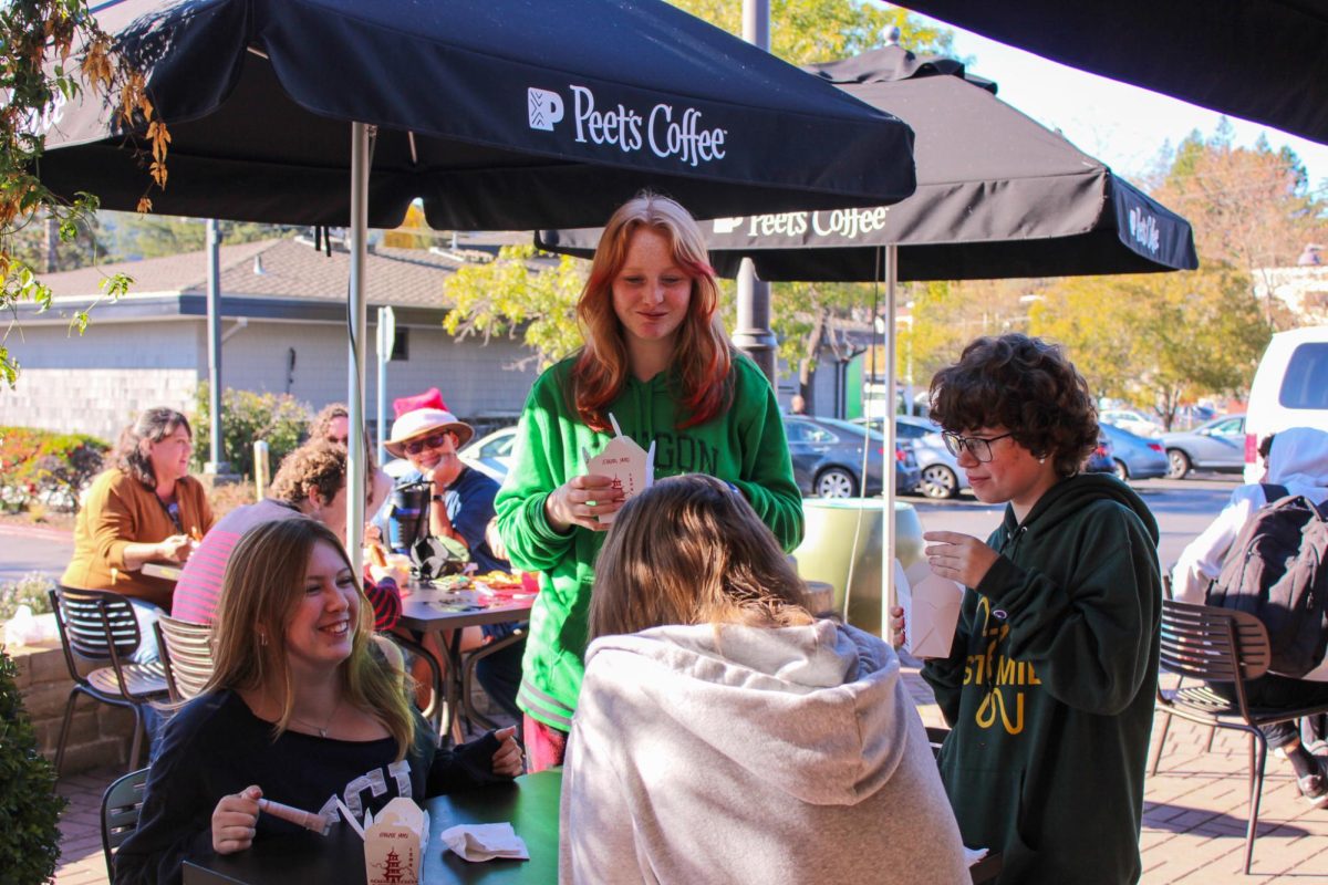 Students enjoy their food outside of Peets Coffee at lunch.
