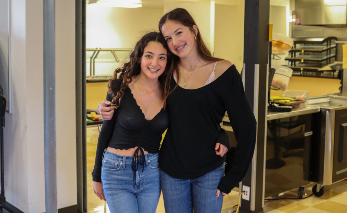 Freshmen Alexandra Berry and Lola Capobianco wear matching shirts and jeans for Twin Day.