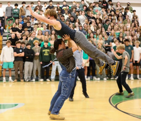 Senior Isaia Rasmussen gets lifted up by senior Jacob Carter during an electric dance battle.