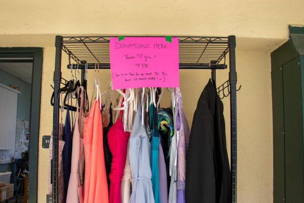A prom clothing rack hangs outside the Peer Resource classroom. 