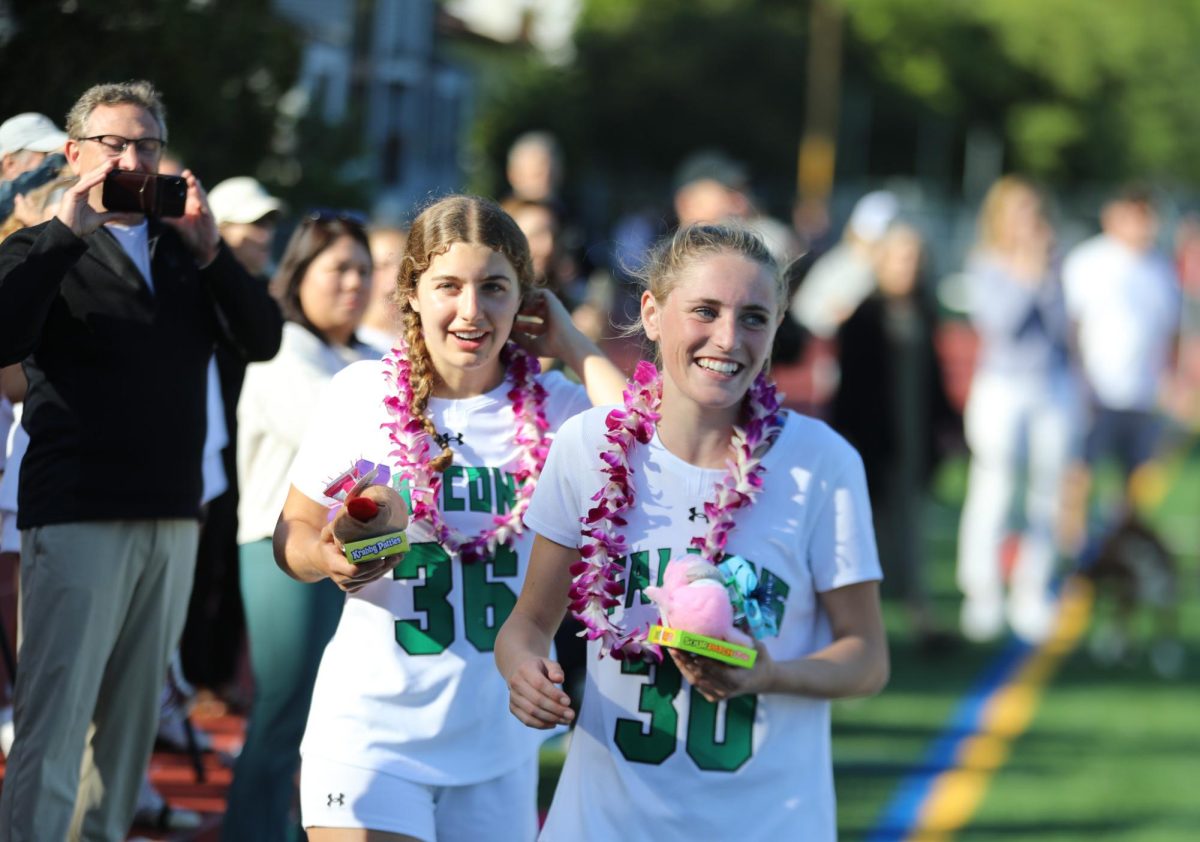 Archie Williams seniors Charlotte Gerner and Isabelle Connolly recieve gifts during senior night.