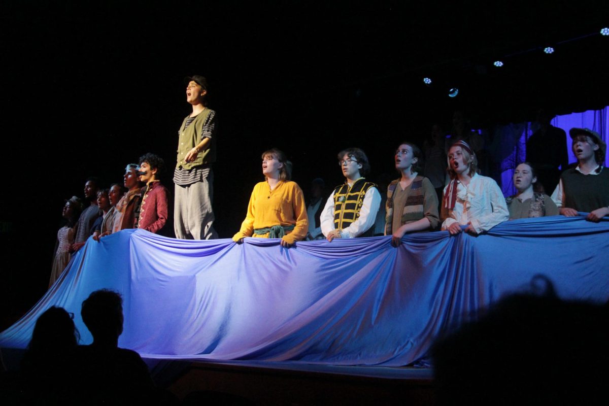 The+entire+cast+of+Peter+and+the+Starcatcher+sings+a+rousing+song+at+the+end+of+Act+I+of+their+show.+%0A