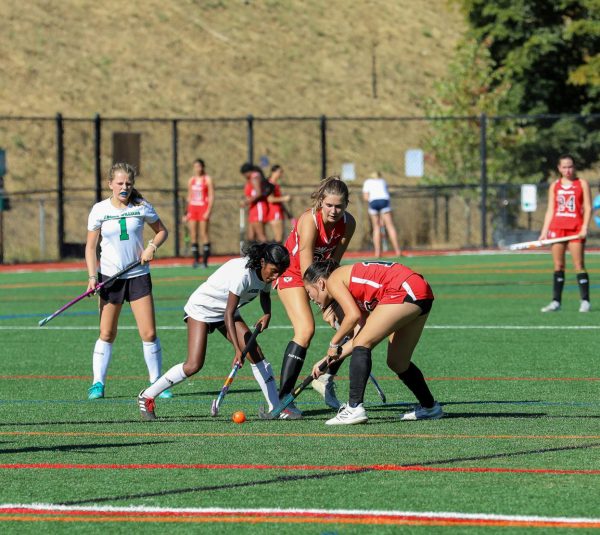 Junior Sarala Rosen lunges for the open ball against two Wildcats.
