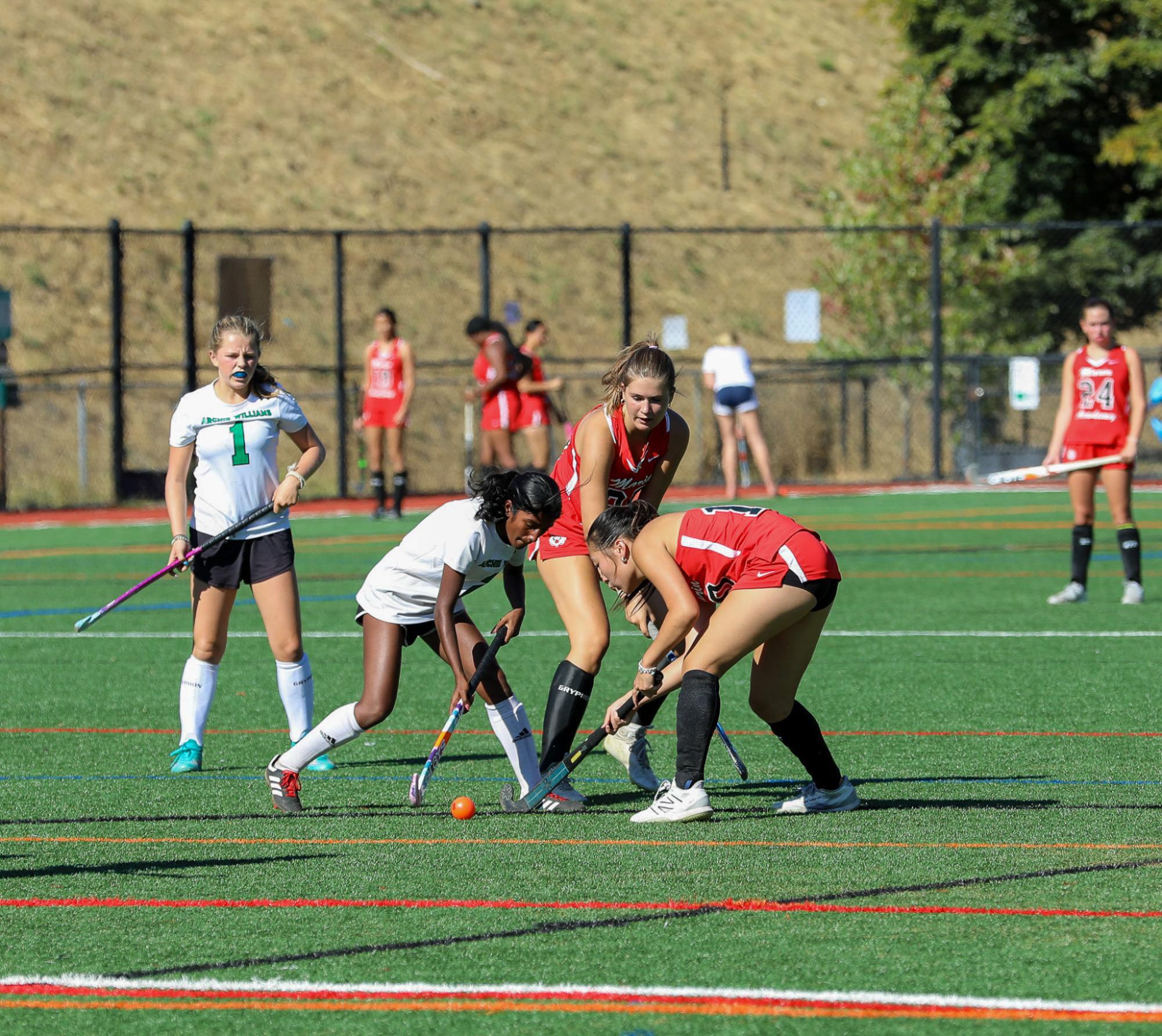 Junior Sarala Rosen lunges for the open ball against two Wildcats.
