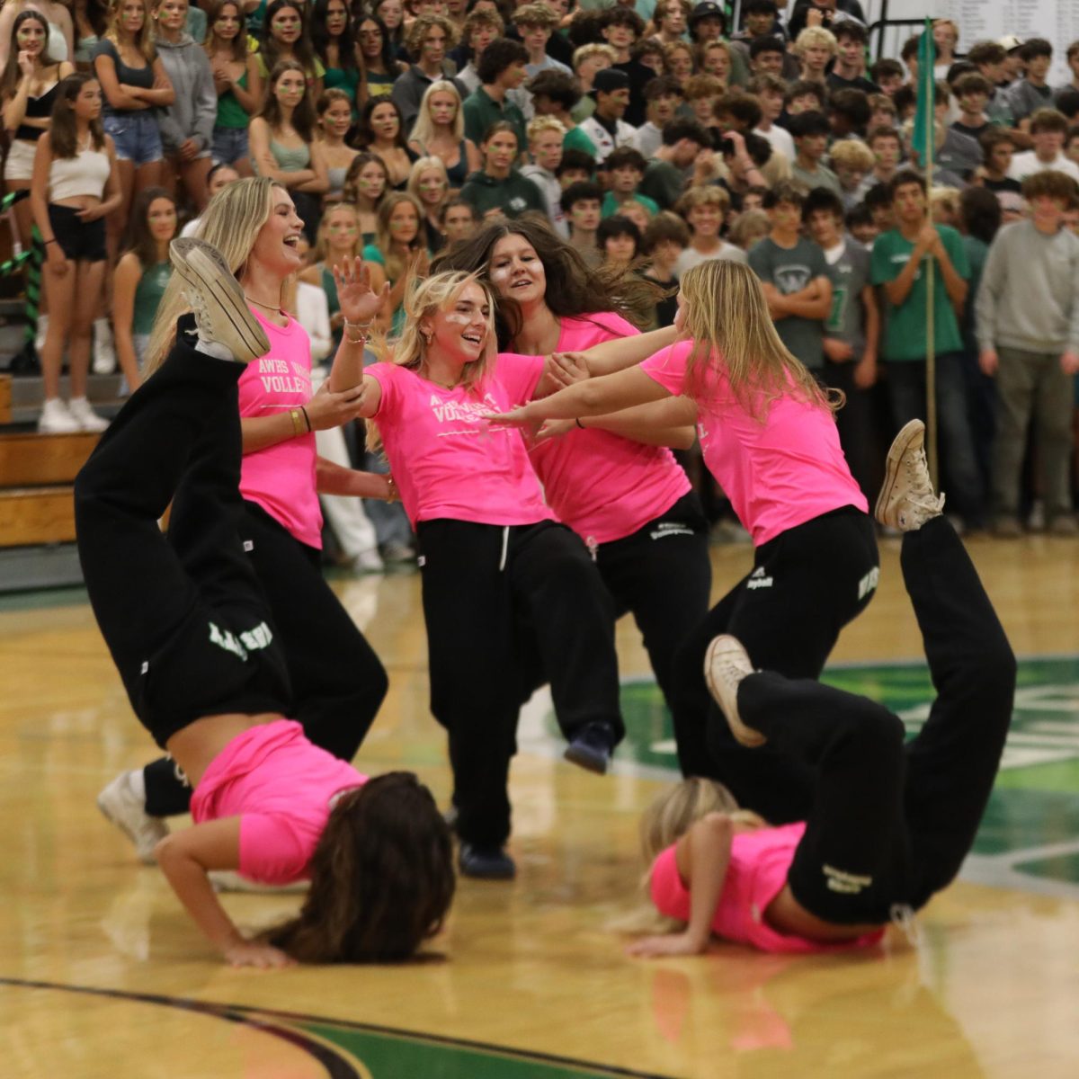 Varsity Volleyball does their team dance during the homecoming rally.