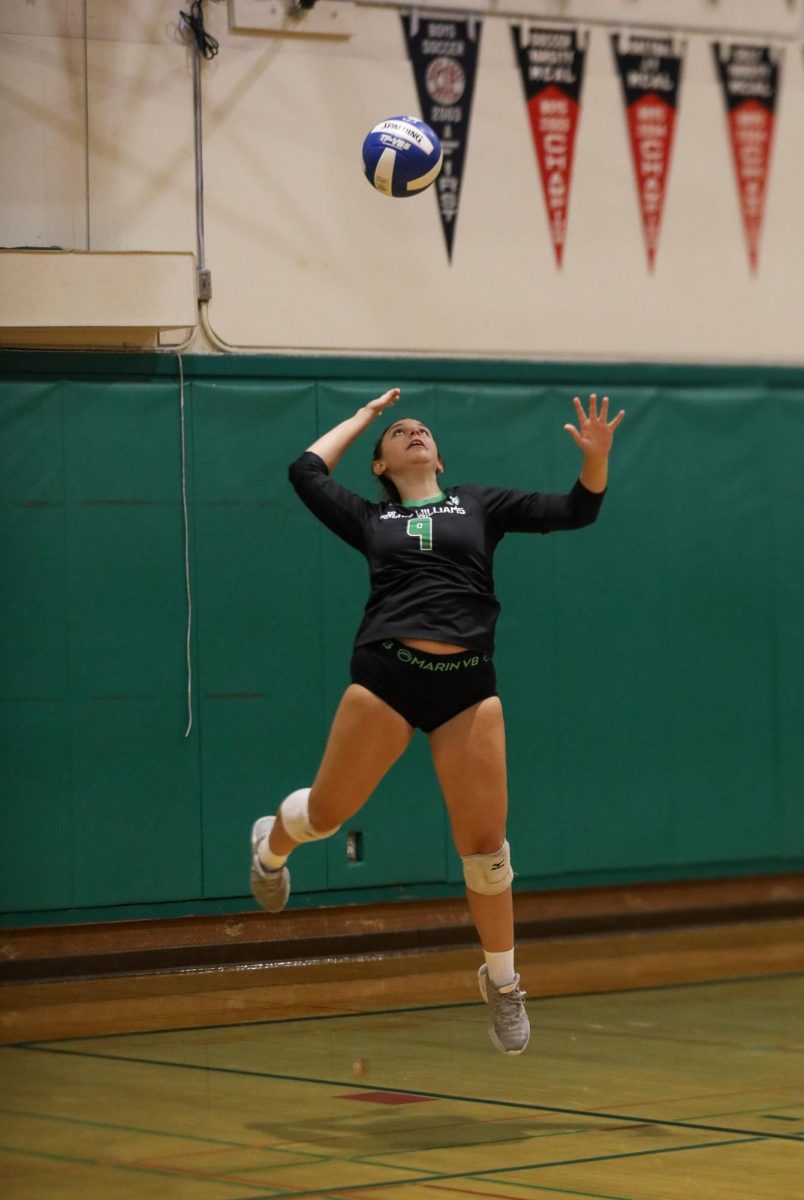 Archie Williams junior Alyse Rosen serves the ball during the first set of the game.