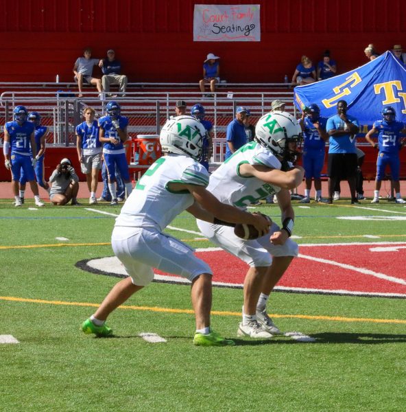 Junior Quarterback Ronan Foley fakes a handoff to sophomore running back Nate Ryan.