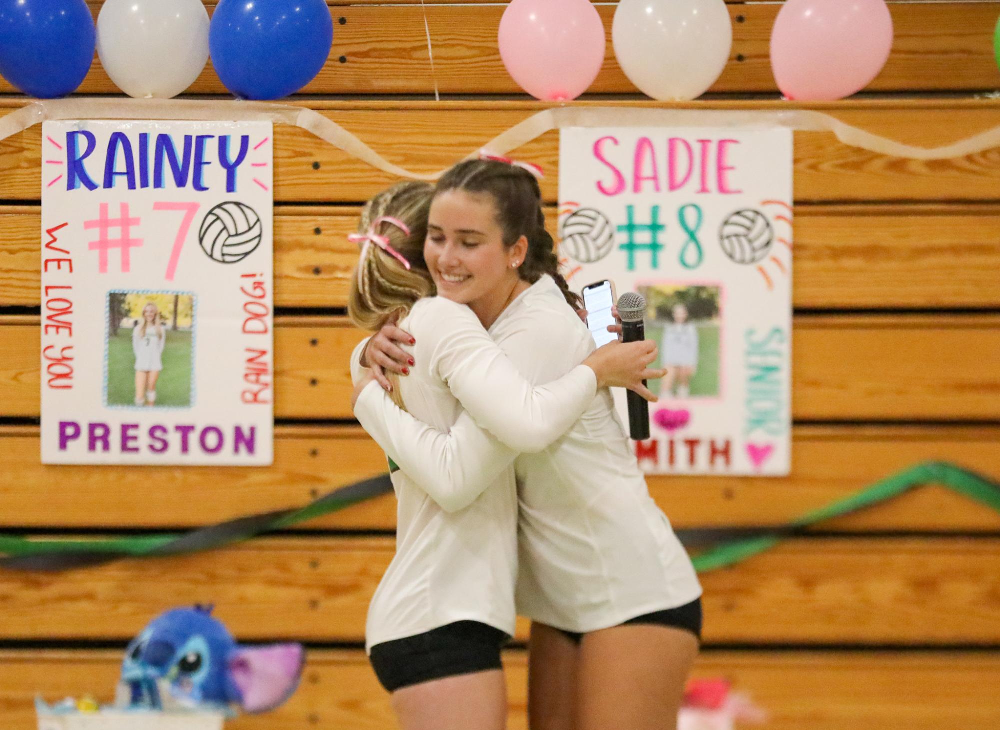 Archie Williams varsity girls volleyball team junior Mia Hermans and senior Sadie Smith share a hug after speeches honoring the seniors.