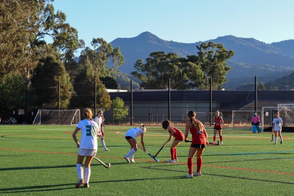 Freshman Eva Montgomery dribbles up the Redhill field during a game against Redwood High School.